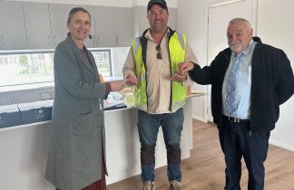 RNH CEO Jenni Masters (left) and Project Support Officer Bernie O'Connor are shown accepting the Hopetoun duplex keys from Swanbuild Site Supervisor Brad Dobson.