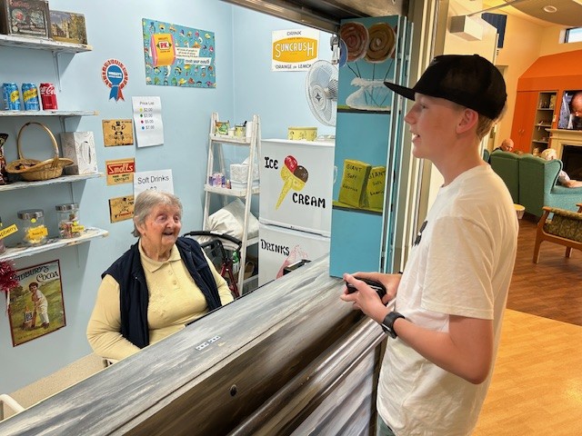 Betty Krahe serving great grandson