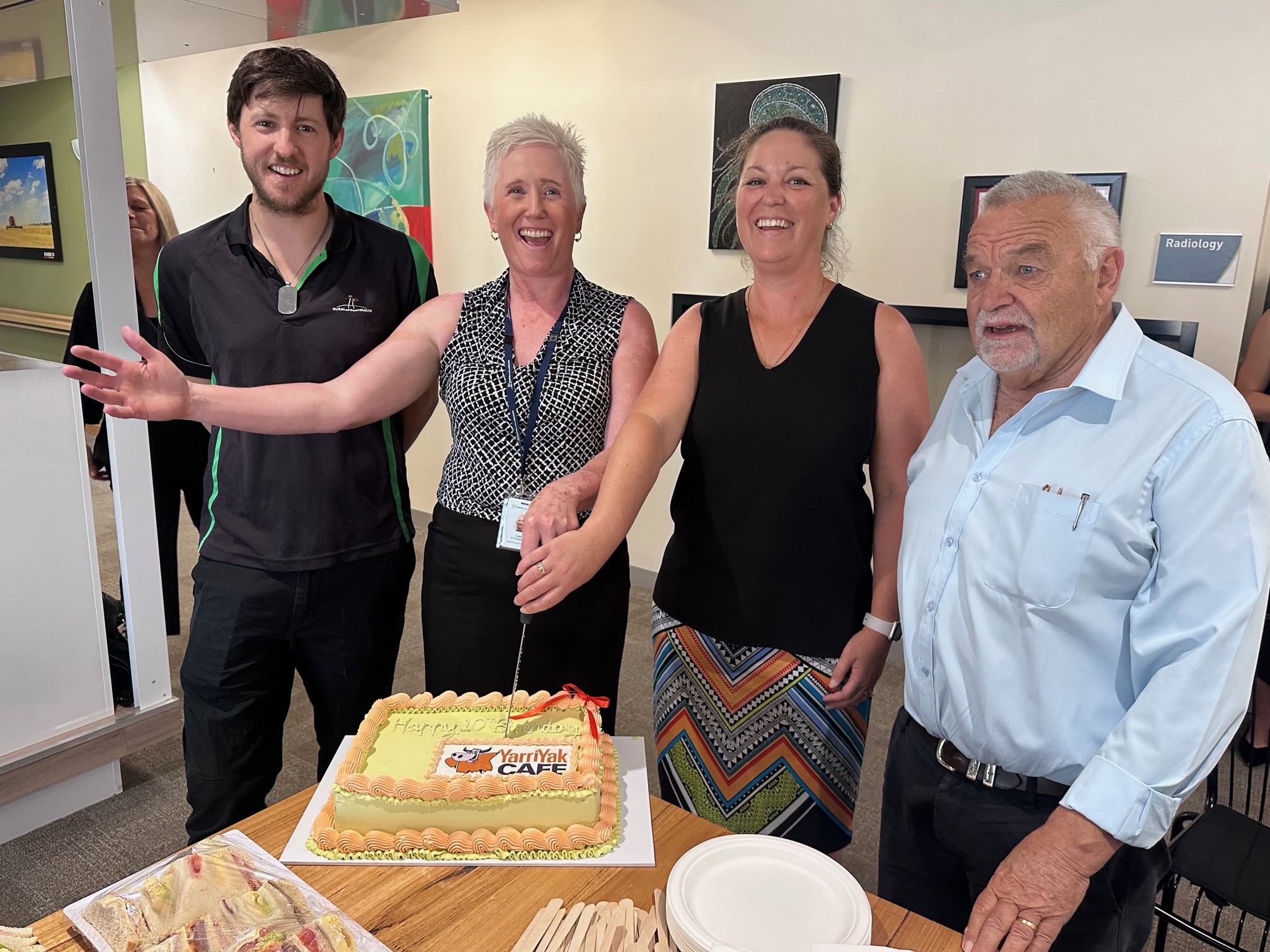 YY Cafe th birthday cutting cake