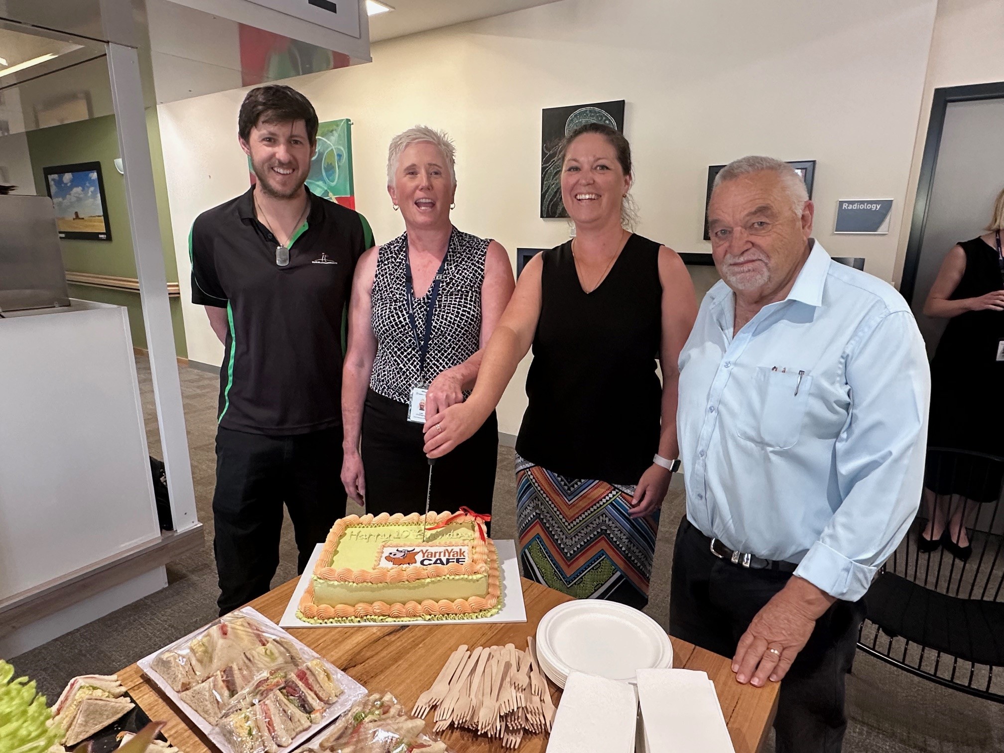 YY Cafe th birthday cutting cake